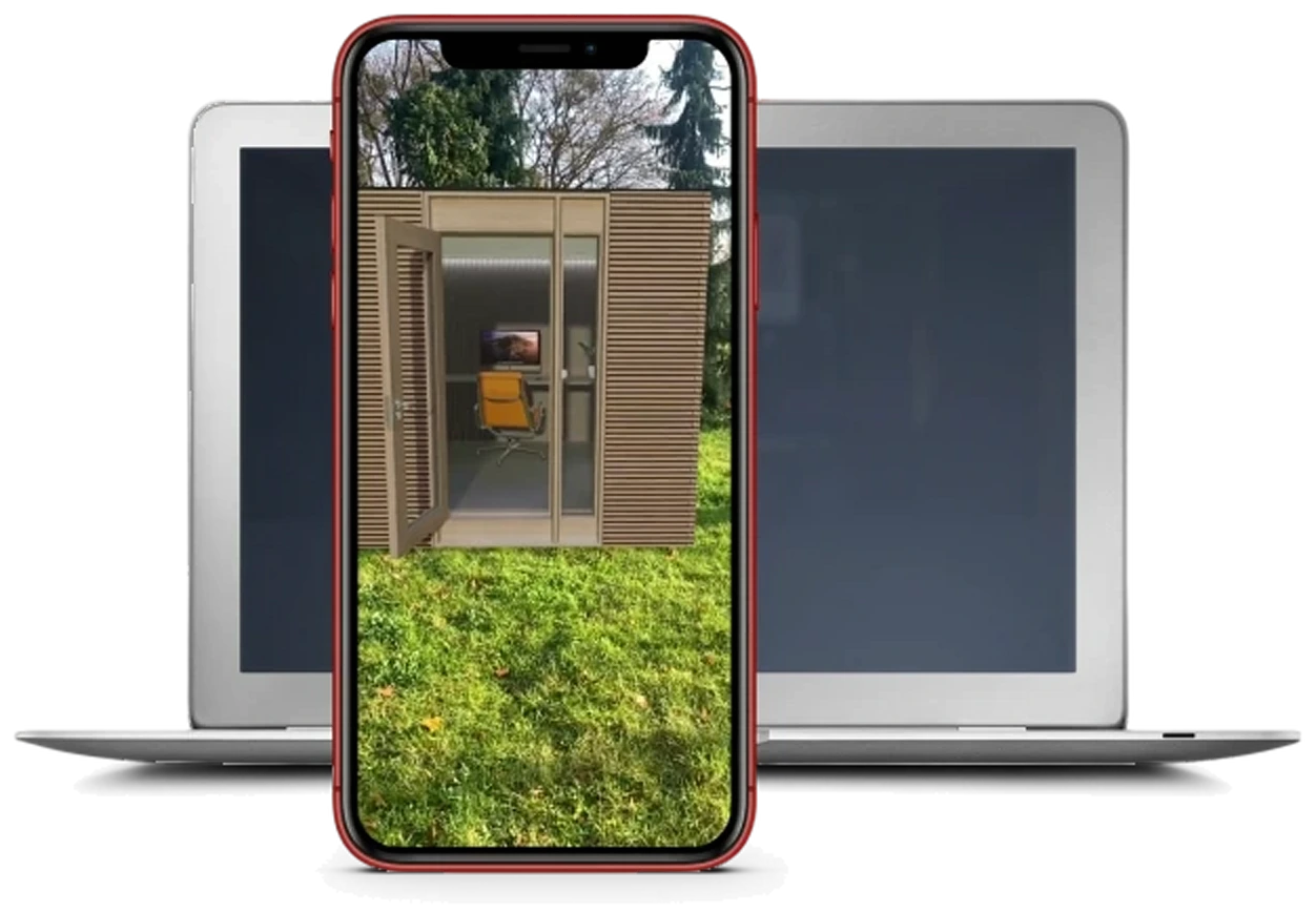 A phone held up in a garden, the Pure Office cabin standing on the lawn through it at full size, with the same configuration open on a laptop behind